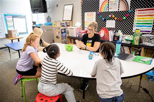 Teacher works with students