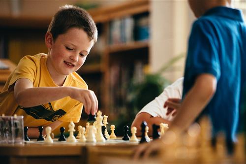 Grandin Court student plays chess.