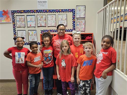  Teacher A.Allen standing with students all dressed in red for Red Ribbon Week