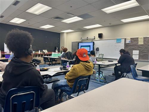 students sitting at tables in a classroom