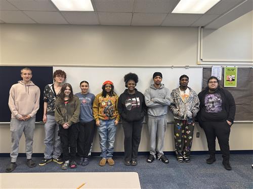 students standing in front of a white board