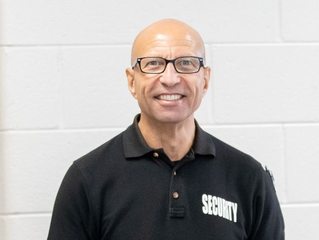  A School Security Officer smiles at the camera. 