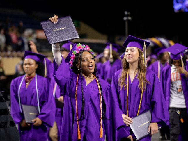  Student holding diploma at graduation