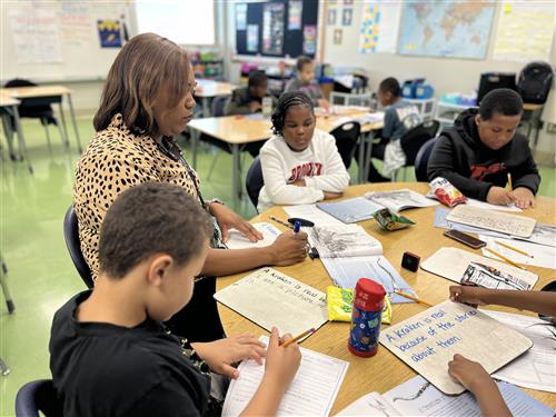 Teacher working with students