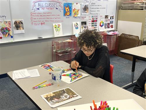 Student painting a portrait