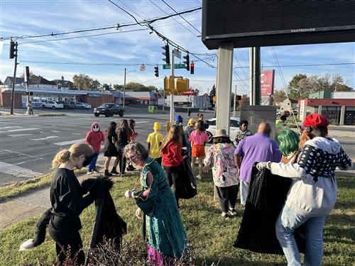 Students pick up litter on the corner of 9th street