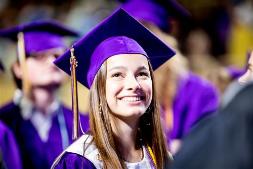 Patrick Henry senior smiles at her family during graduation