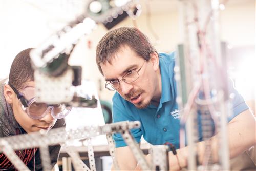 A student works on a robot.