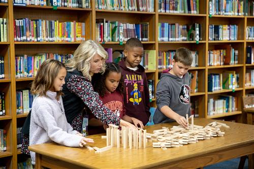 Students and teacher in library